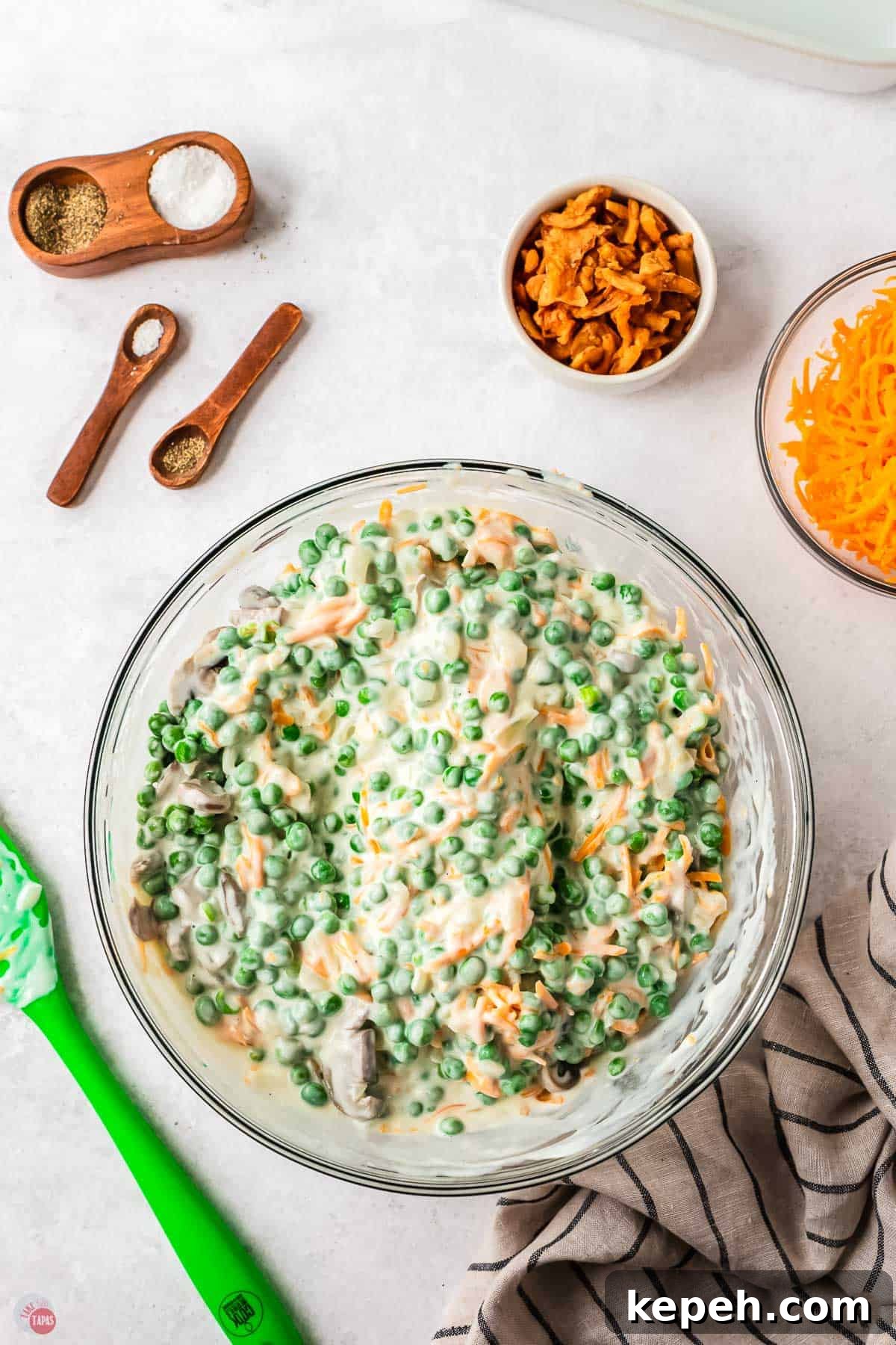 Classic Green Pea Casserole Recipe for Family Dinners 6 peas, cheese, and cheese sauce in a bowl