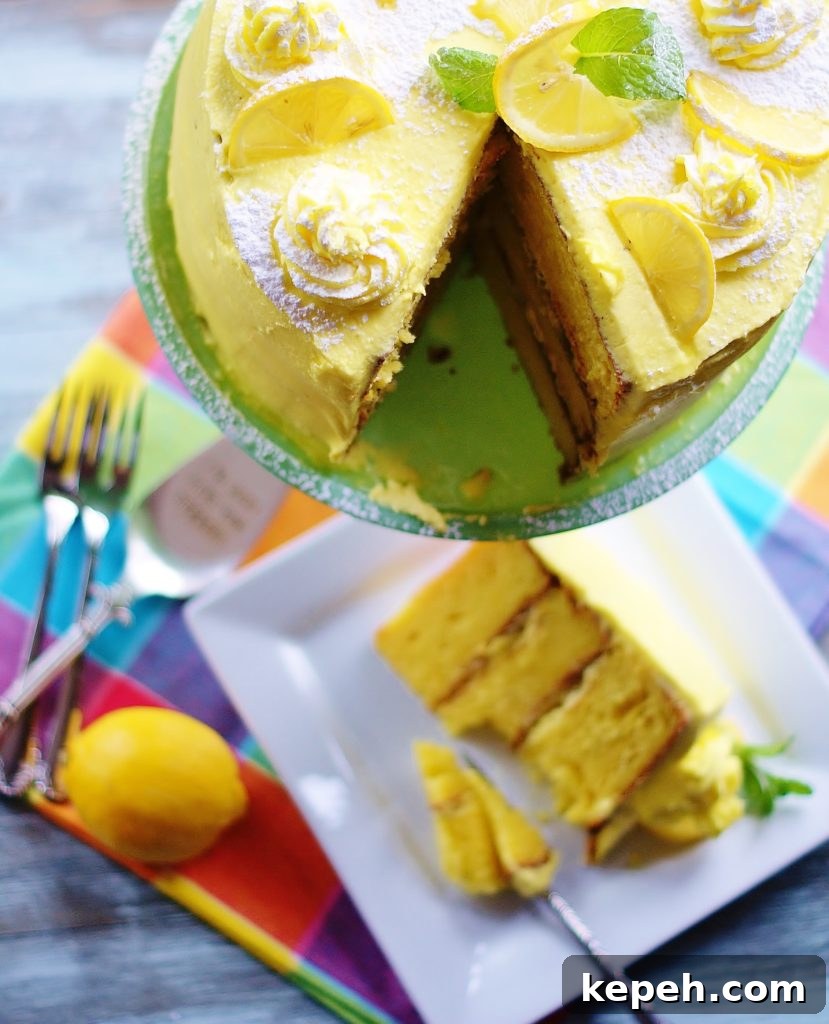 Close up of the top of the lemon cake with a triangular slice missing. A slice of cake is in the background.