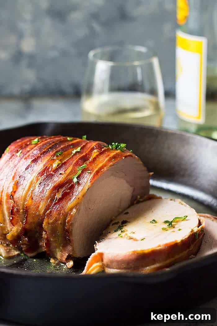 Bacon Wrapped Pork Loin sliced in cast iron skillet