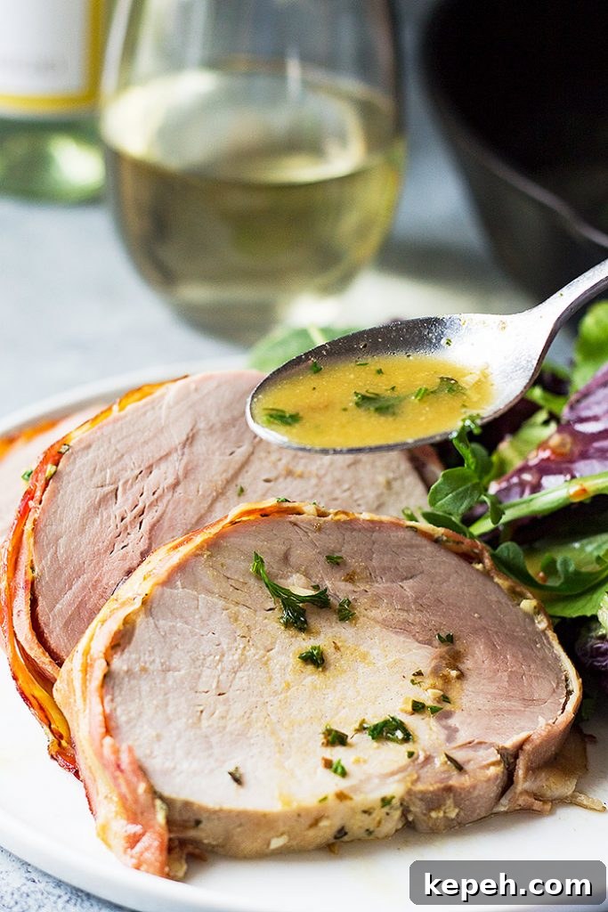 Spooning white wine sauce over slices of pork.