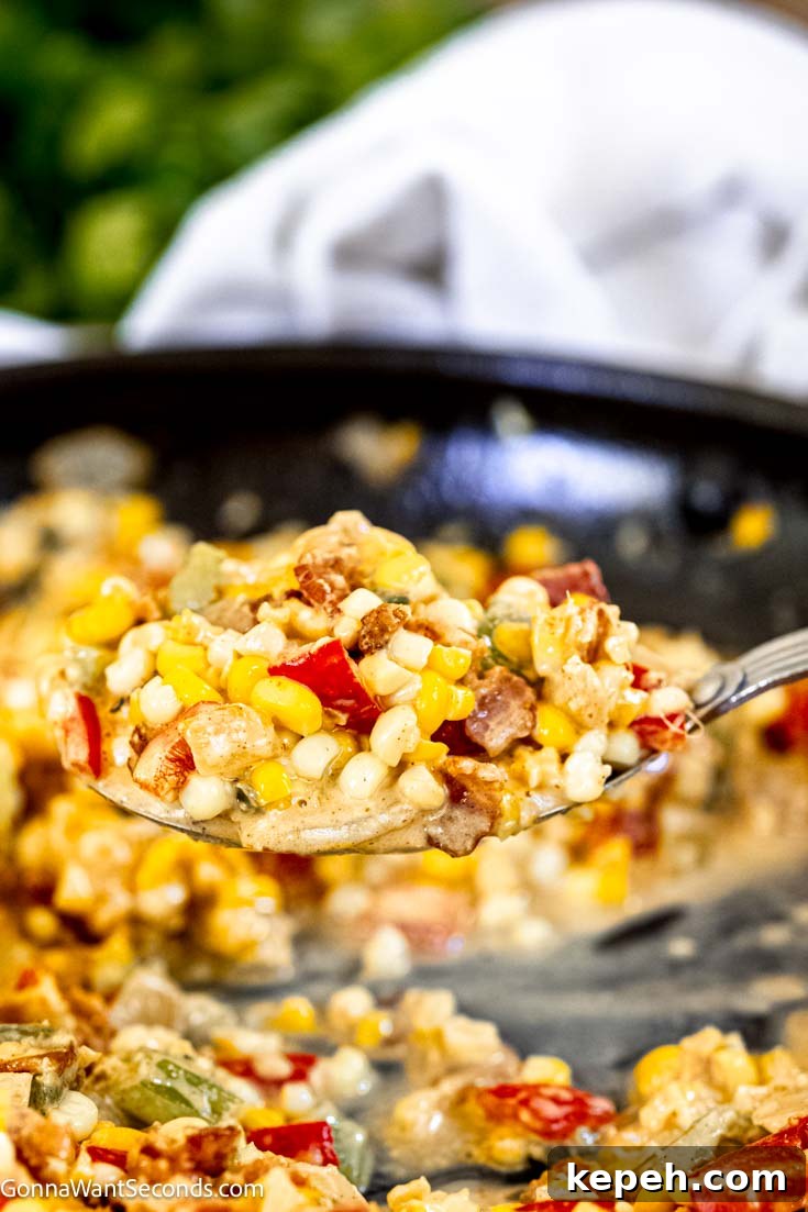 ladle scooping maque choux from a skillet
