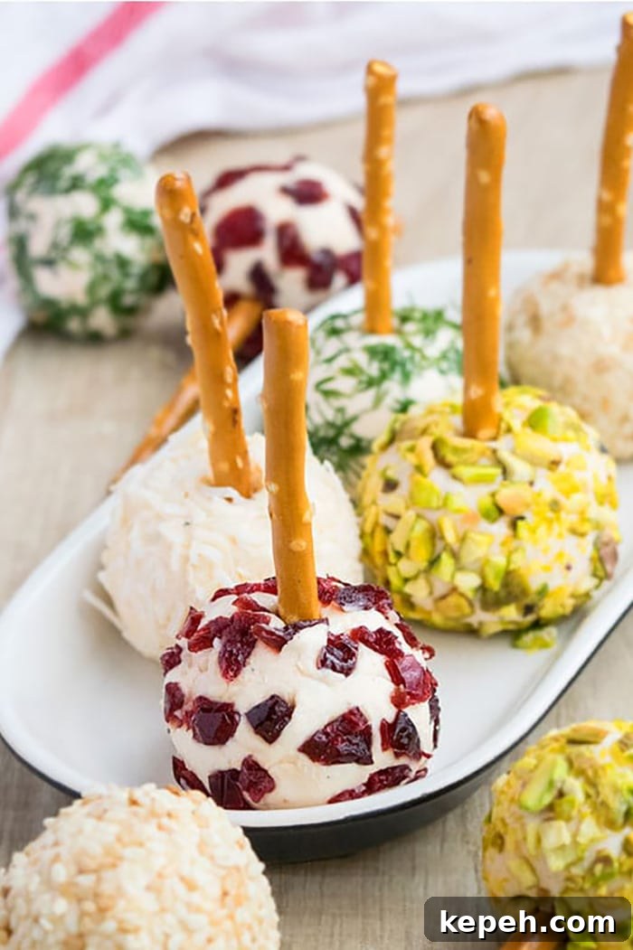 Platter of Variety of Mini Cheese Balls on White Plate on Wood Surface