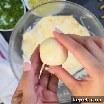 Mixture being rolled into a small ball. 
