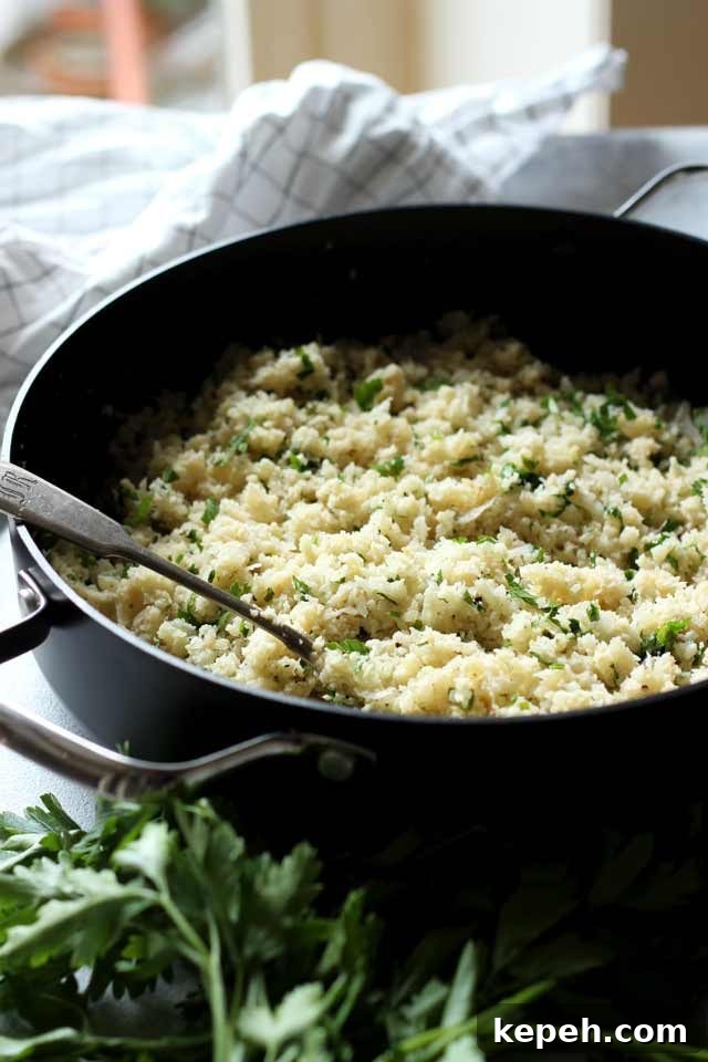 Cauliflower Rice: How to Make It + 16 Delicious Recipes 2 Cauliflower Rice in a Skillet with a Spoon