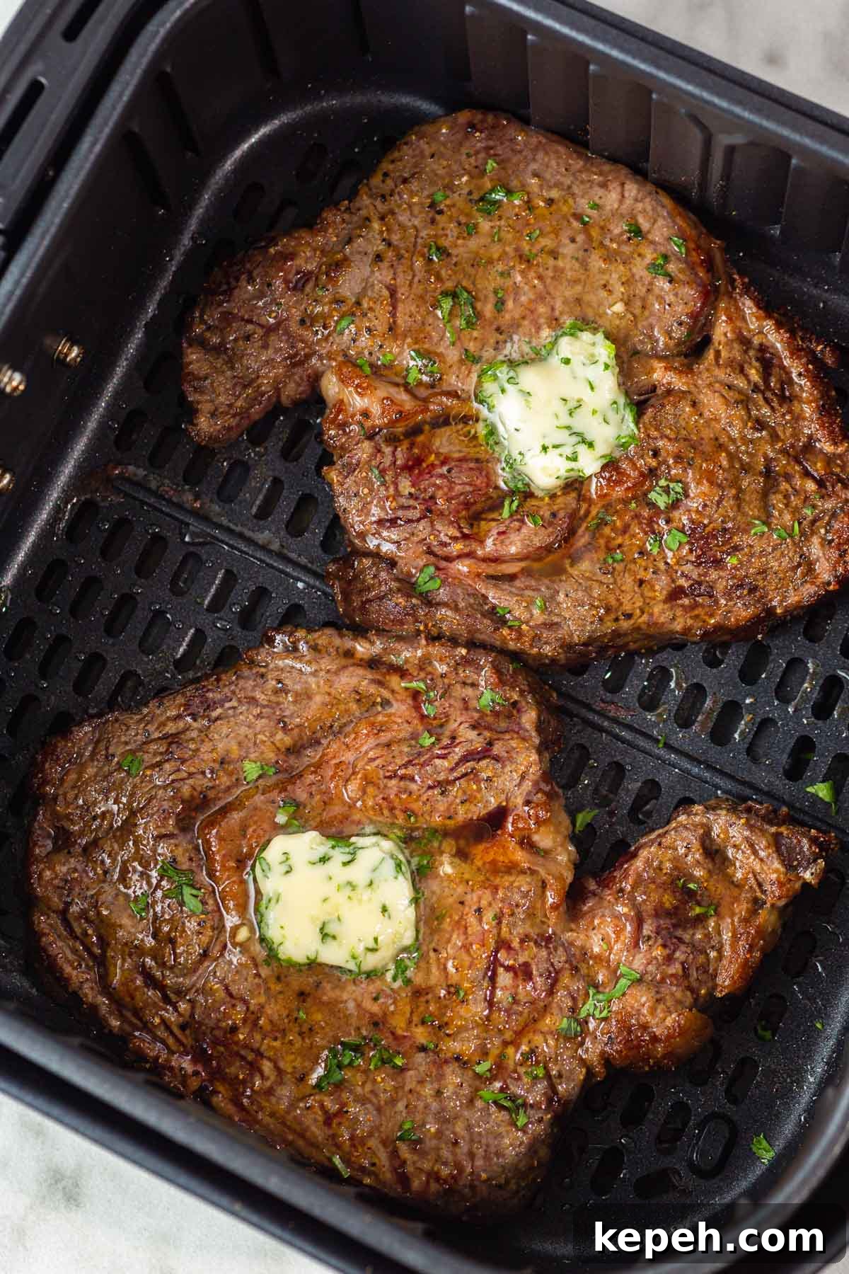 Perfect Ribeye Steak in the Air Fryer: Juicy, Quick Method 2 rib eye steak with garlic herb butter in the air fryer.