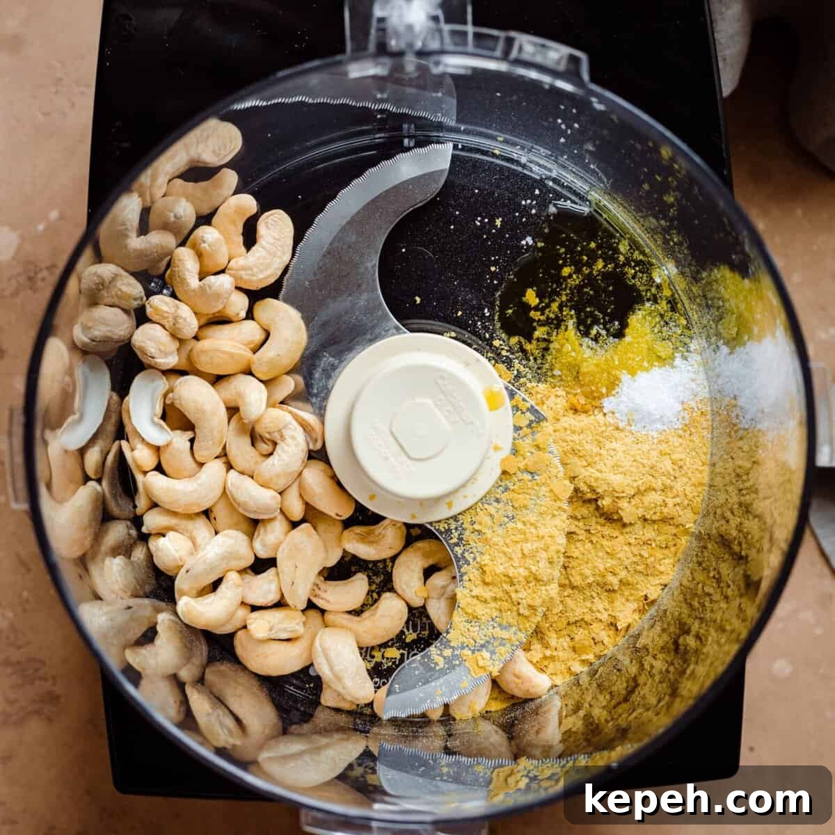 cashews and nutritional yeast in food processor for cashew parmesan.