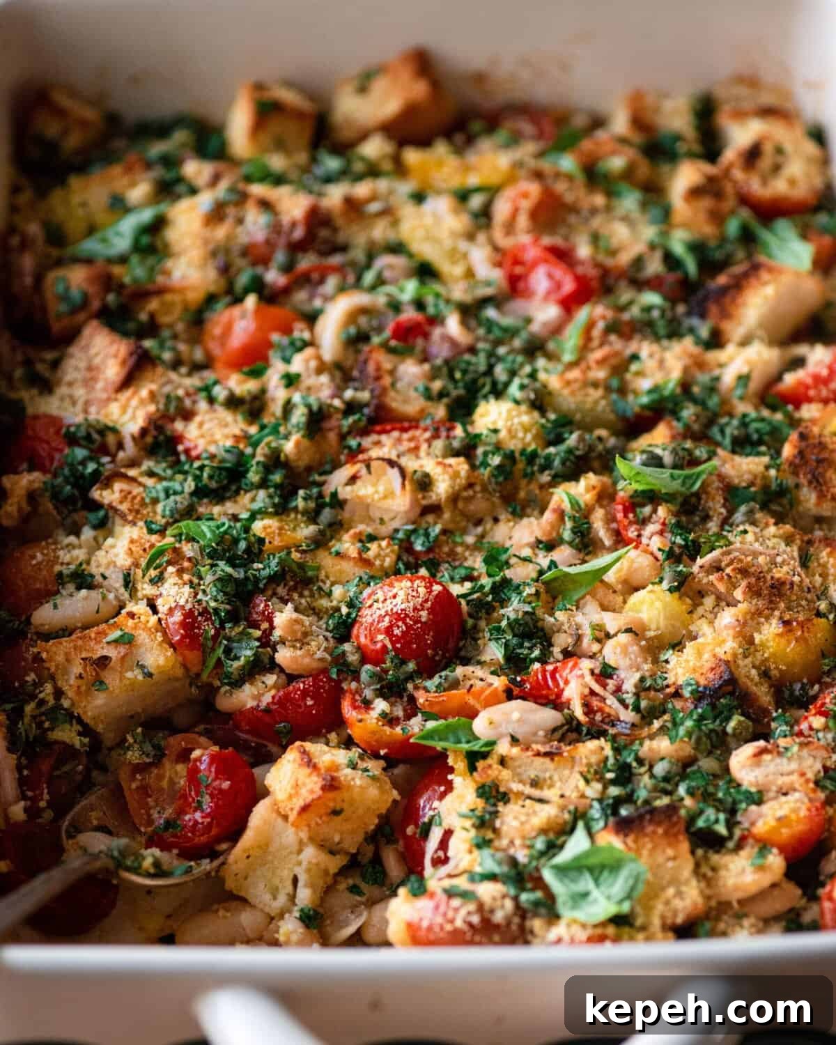 closeup of tomato and white bean casserole with fresh basil