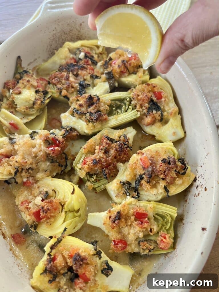 Squeezing lemon wedge over baked artichoke hearts, Italian-style.