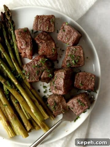 steak bites with asparagus on a plate