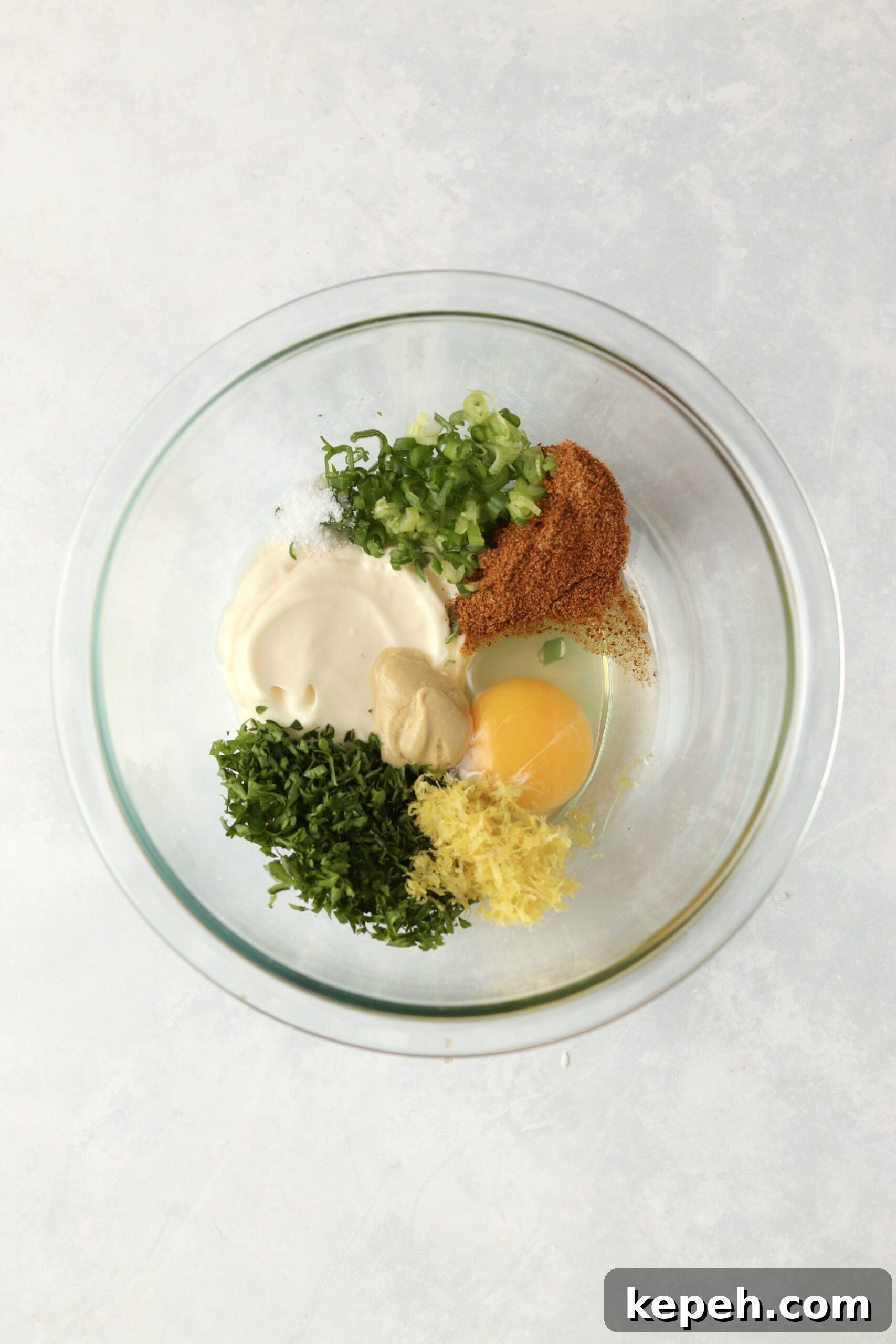 Crispy Air Fryer Crab Cakes Recipe for Golden, Juicy Results 4 egg, mayo, parsley, green onions, old bay in a bowl.