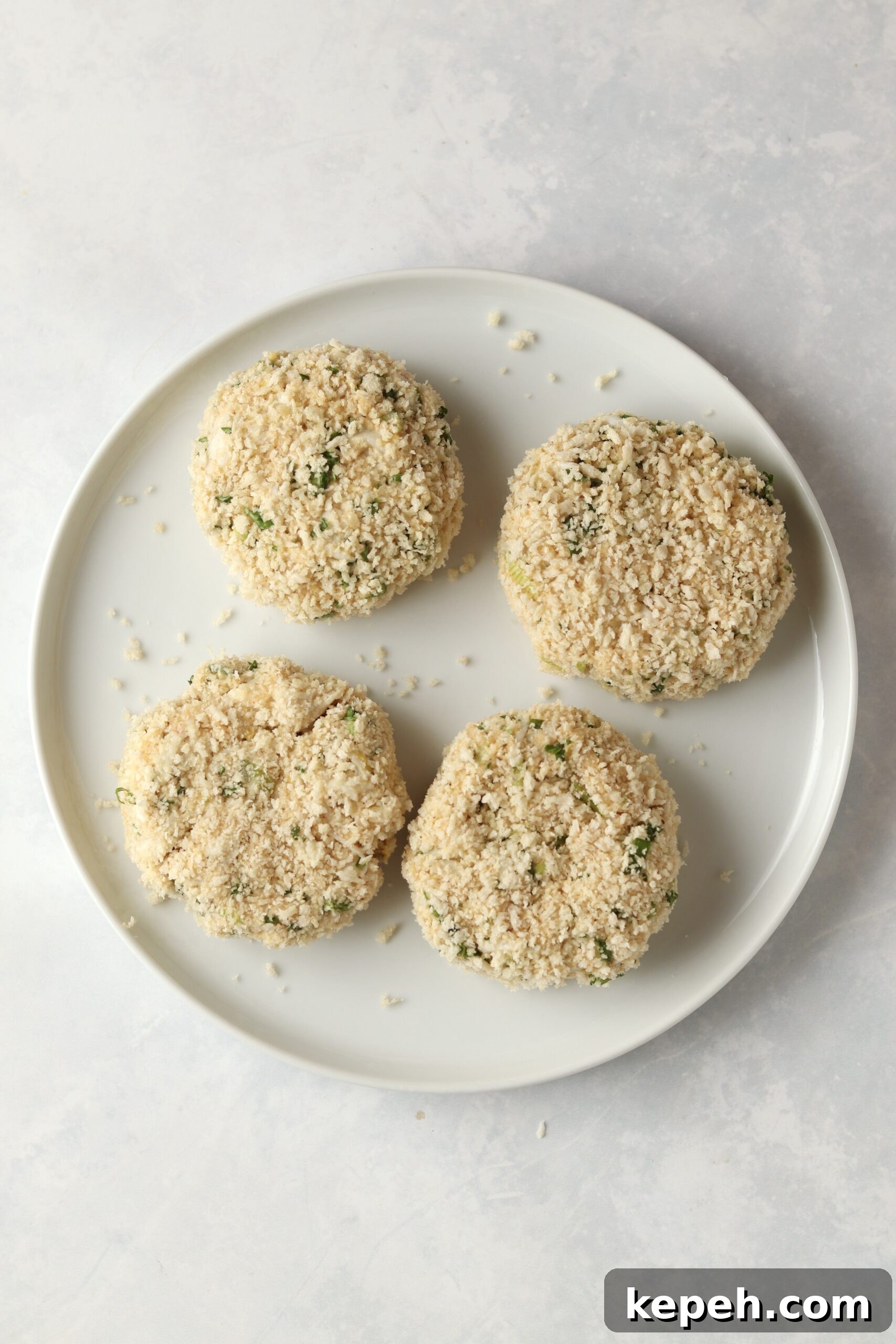 Crispy Air Fryer Crab Cakes Recipe for Golden, Juicy Results 7 uncooked crab cakes on a plate.