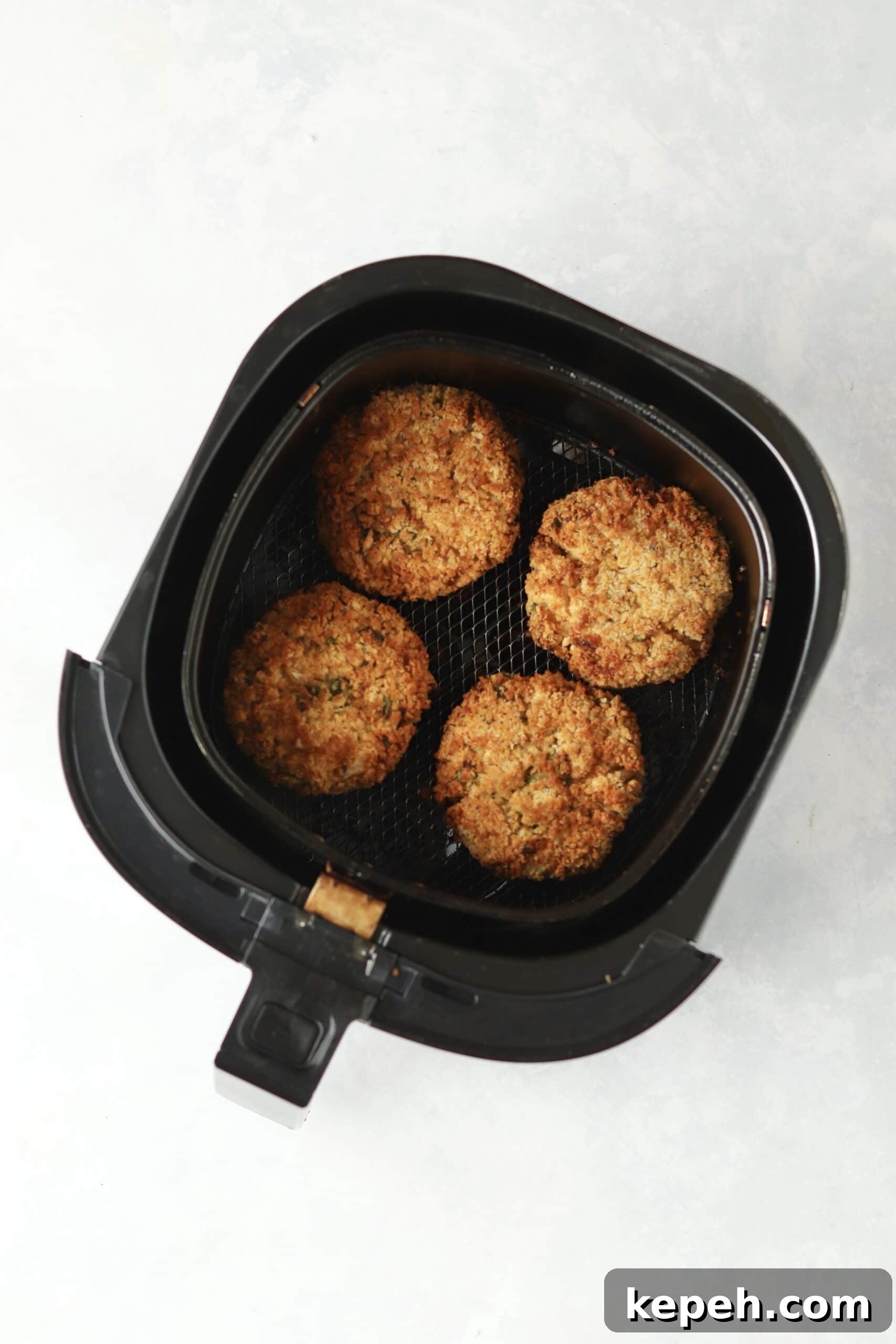 Crispy Air Fryer Crab Cakes Recipe for Golden, Juicy Results 9 cooked crab cakes in air fryer.