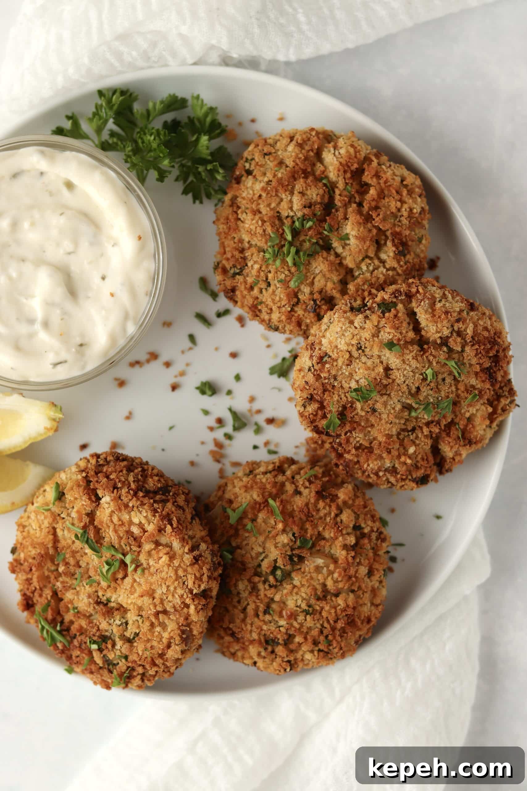 Crispy Air Fryer Crab Cakes Recipe for Golden, Juicy Results 10 crab cakes on a plate with lemon and parsley