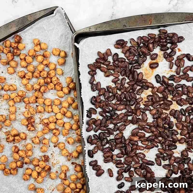 Overhead view of process shot 3 - spread the chickpeas on one baking sheet and the black beans on a second baking sheet. Bake for about 25-30 minutes, remove the black beans and continue to bake the chickpeas for another 15-20 minutes.