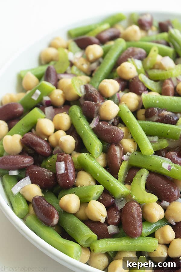 Classic Three-Bean Salad Recipe for Summer Potlucks 2 Three bean salad in a white bowl