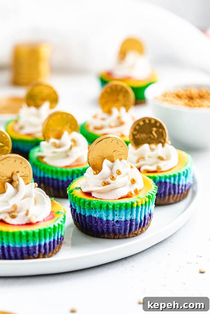 Mini Rainbow Cheesecakes with Pot of Gold Surprise 4 bite-sized cheesecakes on a plate