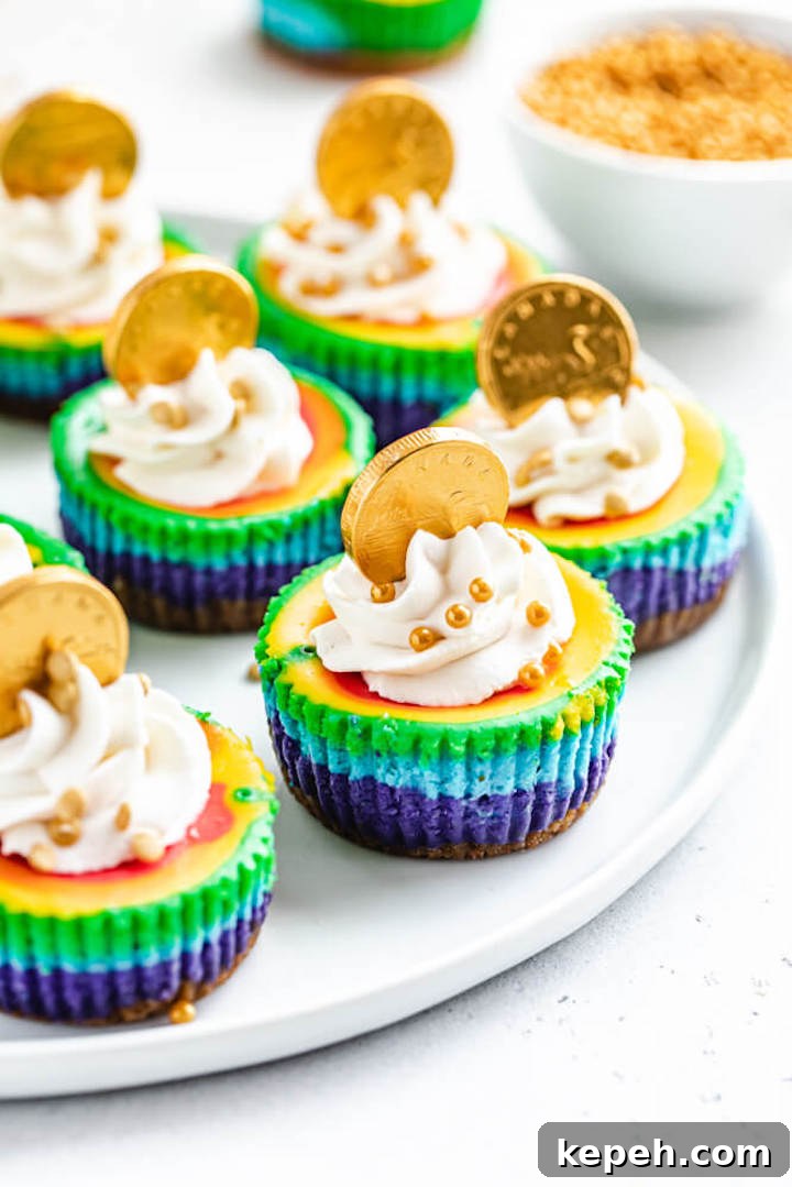 Mini Rainbow Cheesecakes with Pot of Gold Surprise 6 mini cheesecakes on a white plate