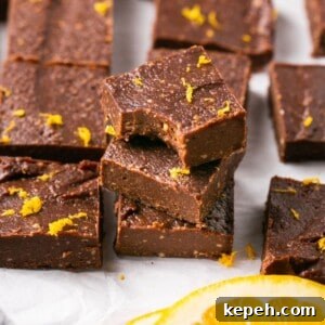 No-Bake Orange Chocolate Fudge Recipe: Zesty Cocoa Treat 14 A stack of three pieces of vegan orange chocolate fudge.