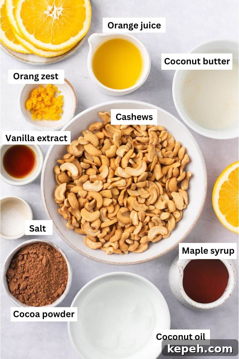 No-Bake Orange Chocolate Fudge Recipe: Zesty Cocoa Treat 3 The ingredients needed to make orange chocolate fudge separated into bowls including cashews, orange juice, coconut oil, maple syrup and vanilla extract.