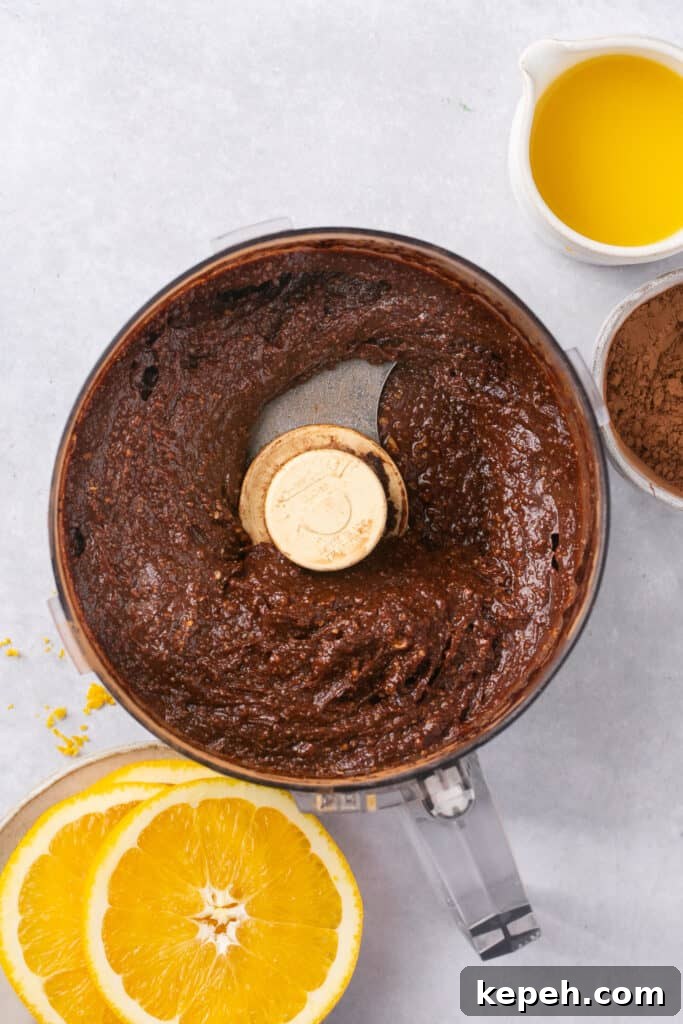 No-Bake Orange Chocolate Fudge Recipe: Zesty Cocoa Treat 5 A food processor filled with a thick chocolate mixture.