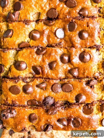 A loaf of gluten free chocolate chip banana bread cut into pieces.