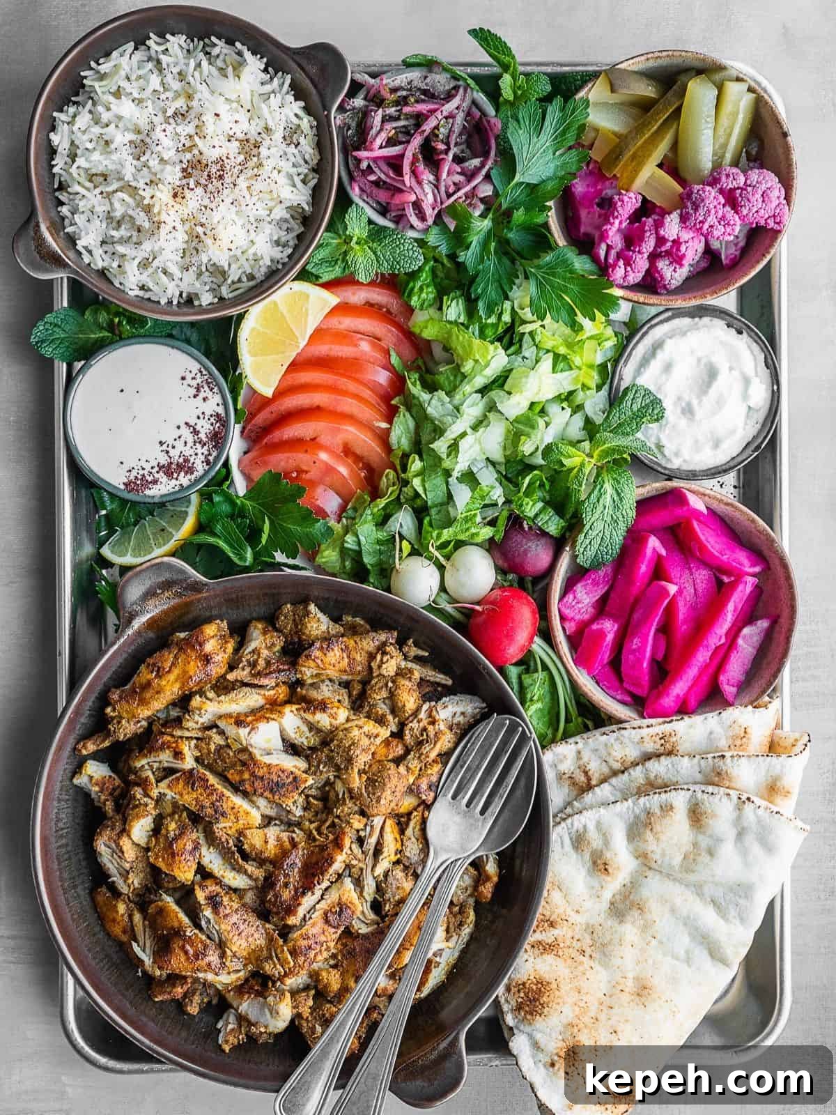 Lebanese Chicken Shawarma Recipe: Wraps or Bowls Made at Home 2 Chicken shawarma platter with all the sides and toppings.