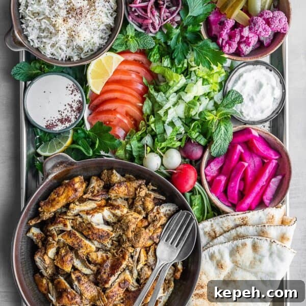 Lebanese Chicken Shawarma Recipe: Wraps or Bowls Made at Home 17 Chicken shawarma platter with all the sides and toppings.