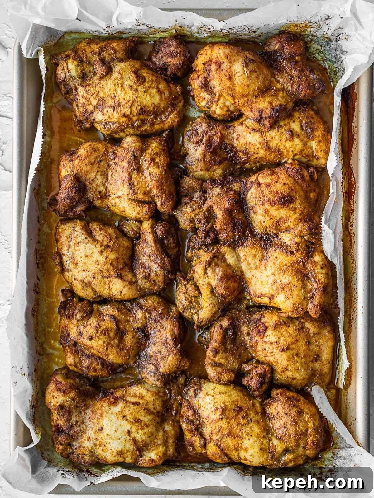 Lebanese Chicken Shawarma Recipe: Wraps or Bowls Made at Home 7 Cooked chicken thighs on a baking sheet.