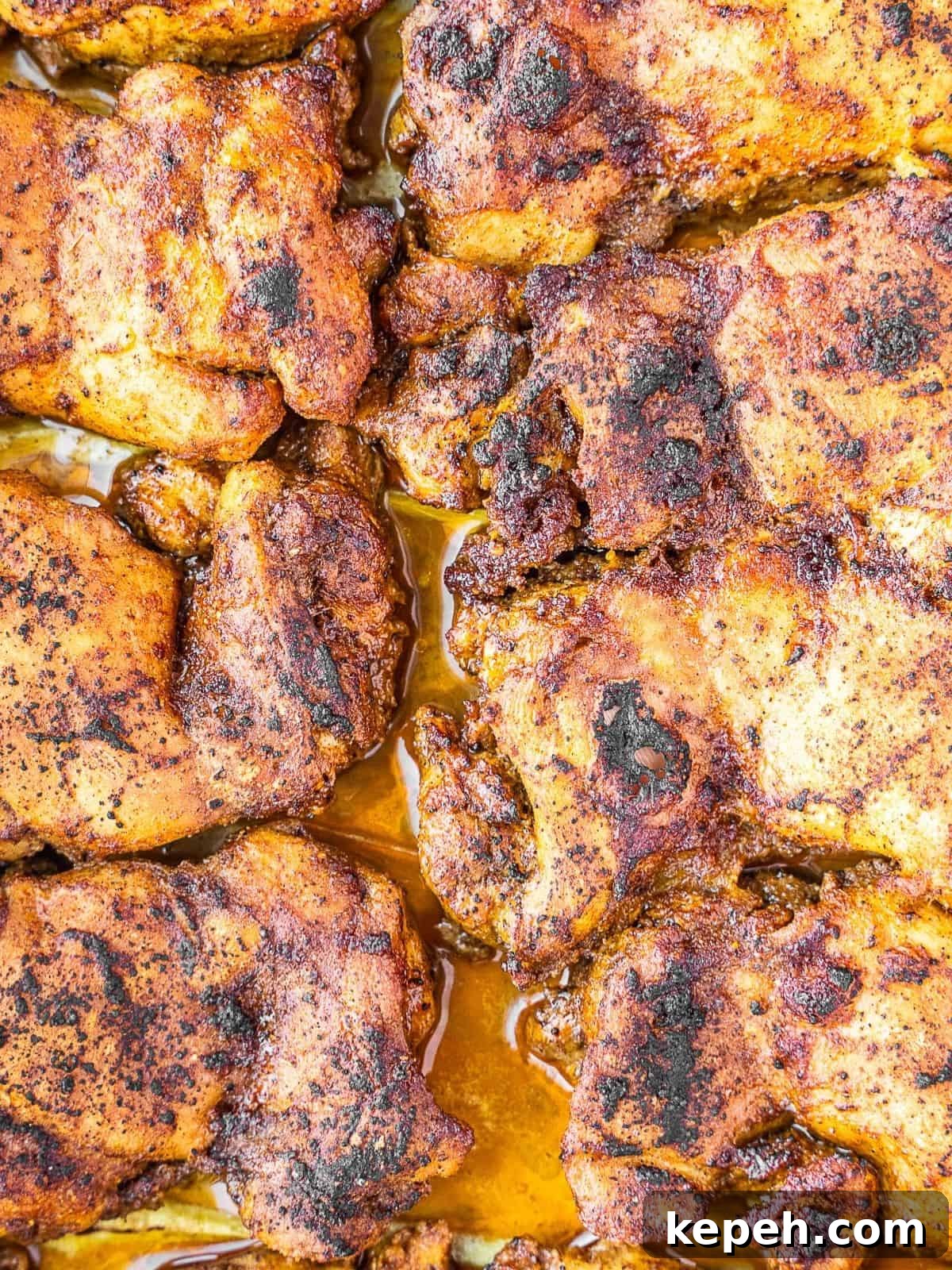 Lebanese Chicken Shawarma Recipe: Wraps or Bowls Made at Home 8 Broiled chicken thighs on a baking sheet.
