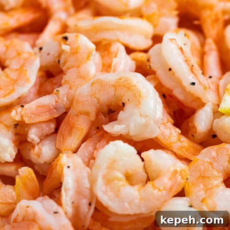 Crispy Air Fryer Shrimp from Frozen in 15 Minutes 4 Close up image of a pile of cooked shrimp.