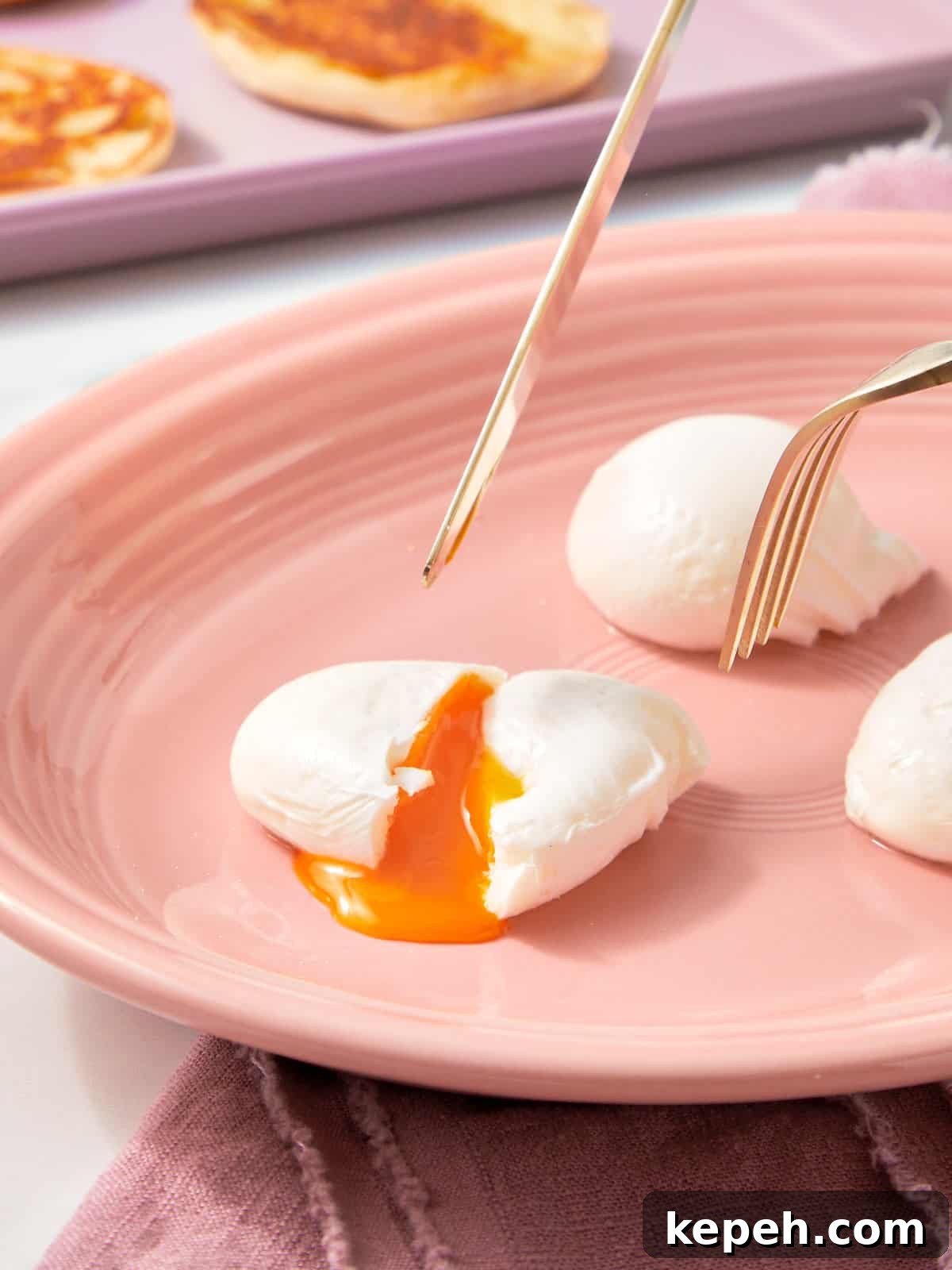 Three poached eggs on a plate, with a fork and knife cutting into one — the golden yolk spilling out softly.