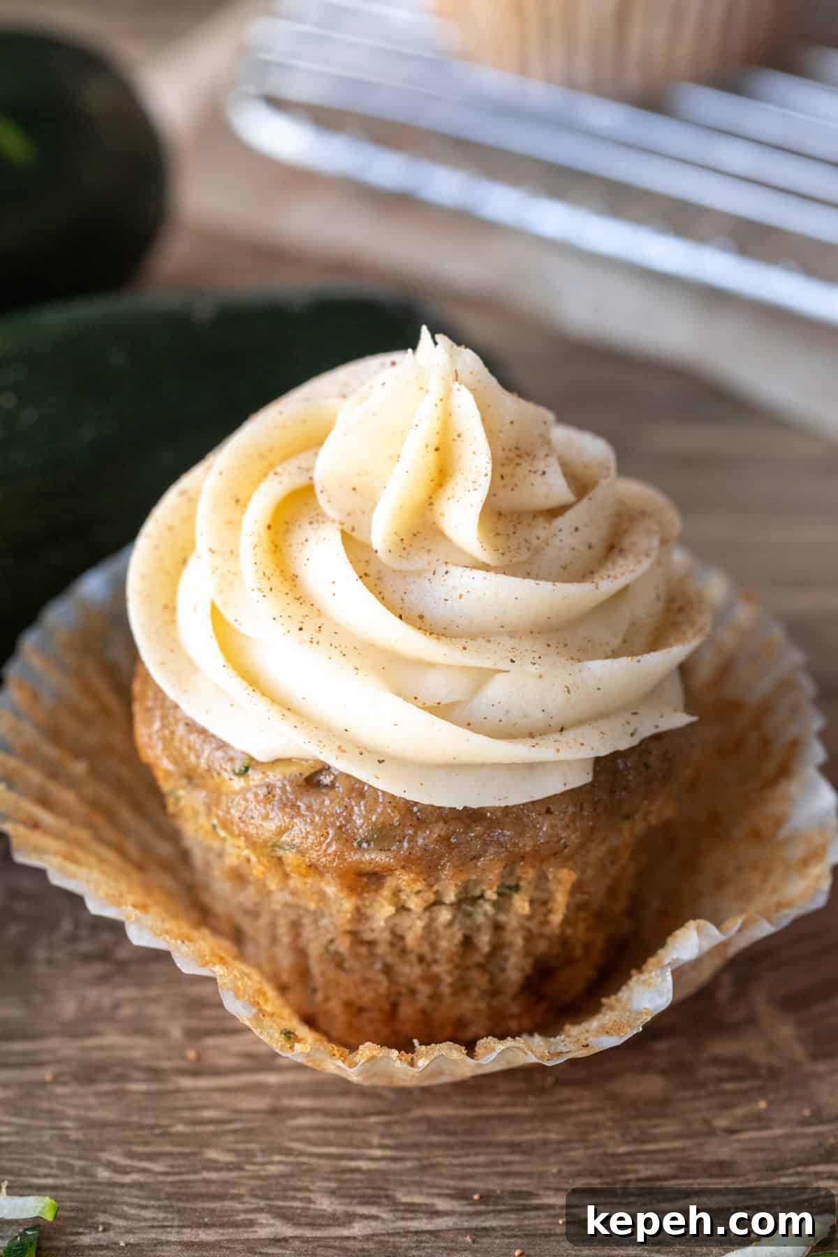 Moist Zucchini Cupcakes with Cream Cheese Frosting 2 Zucchini cupcake with cinnamon cream cheese frosting with cupcake paper peeled back