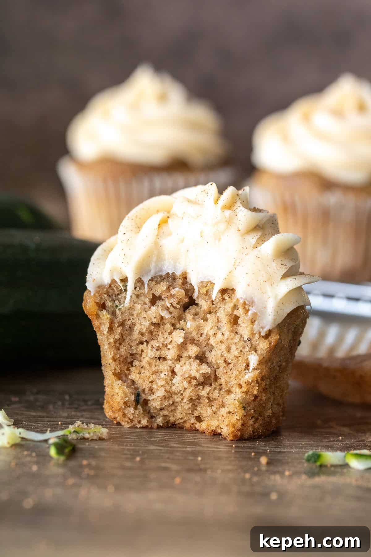Moist Zucchini Cupcakes with Cream Cheese Frosting 8 Zucchini cupcake with cream cheese frosting with bite taken out