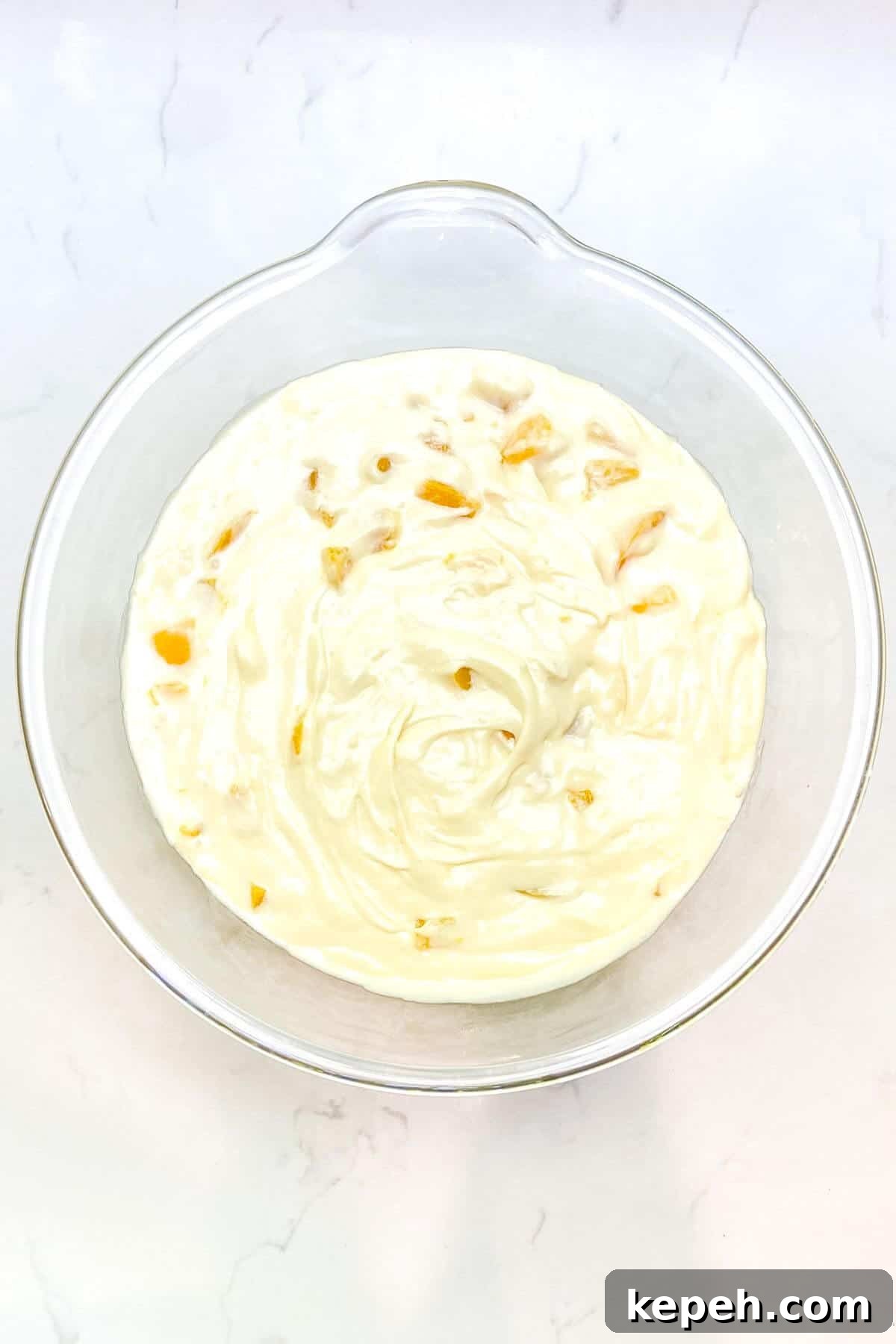 Mixed batter in a large glass bowl.