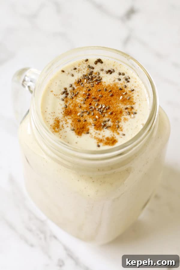 Creamy Chia Banana Yogurt Smoothie Recipe 2 chia banana smoothie in glass jar with cinnamon and chia seeds sprinkled on top