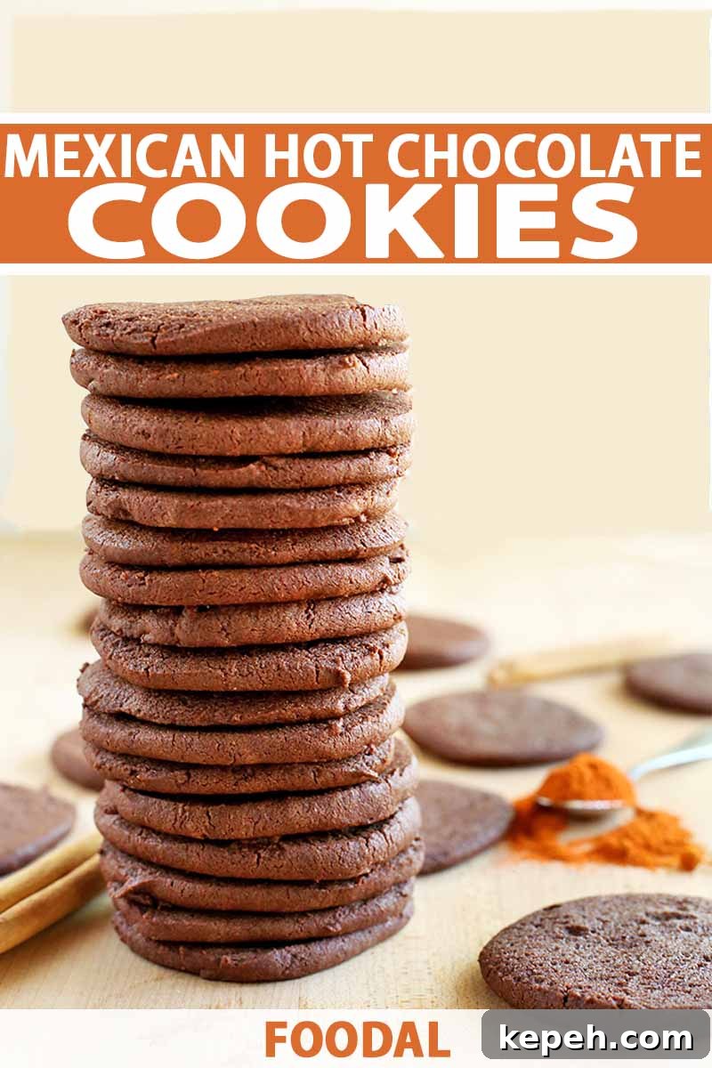 Spicy Mexican Hot Chocolate Cookies to Kick Off Baking Season 2 Vertical image of a stack of chocolate cookies with more scattered on a beige countertop with cinnamon sticks an a slightly spilled spoonful of cayenne pepper, on a light beige background, printed with orange and white text.