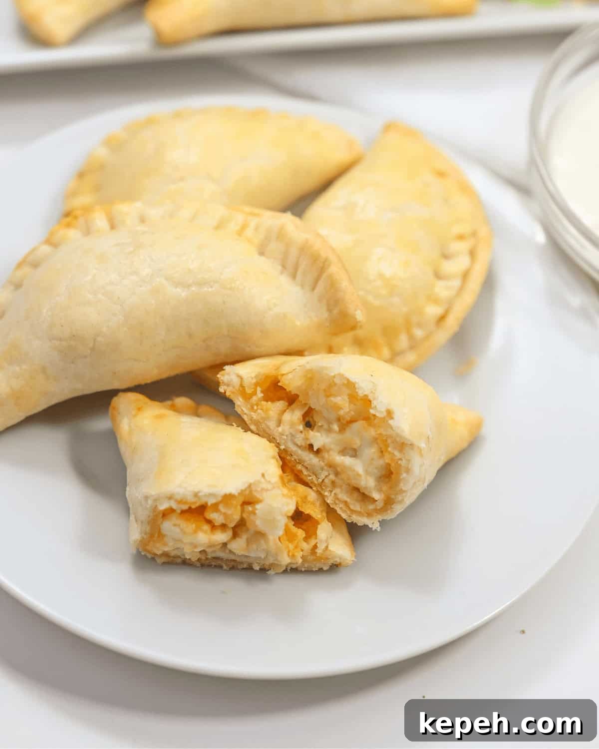 Buffalo Chicken Empanadas Recipe: Crispy Spicy Stuffed Turnovers 3 A plate with a plate of delicious hand pies.