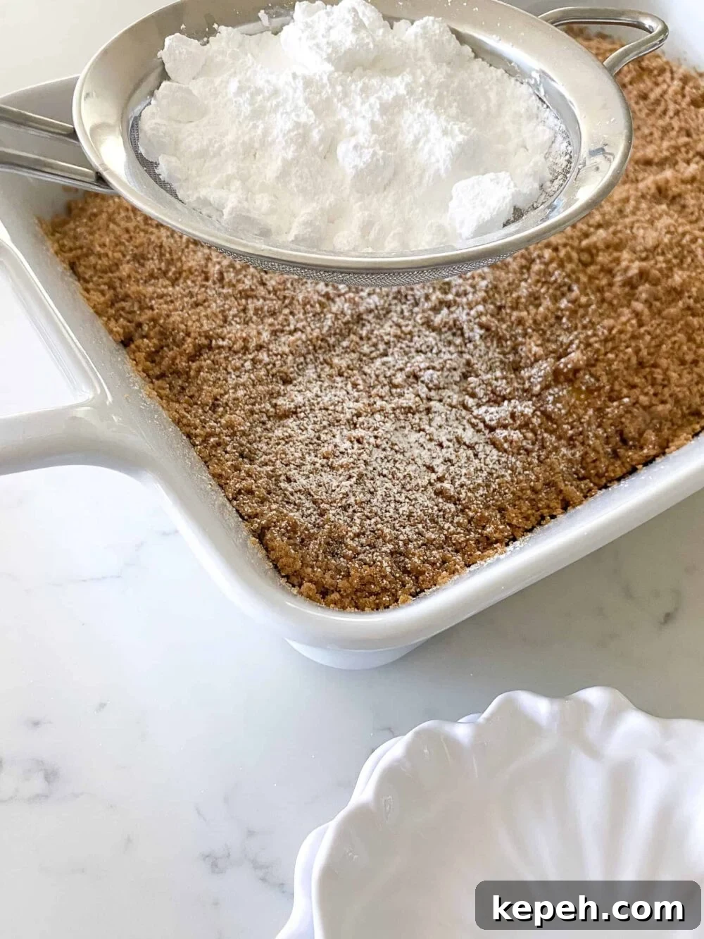 Starbucks Coffee Cake Copycat Recipe — Moist Streusel Coffee Cake 5 sprinkling powdered sugar over baked coffee cake