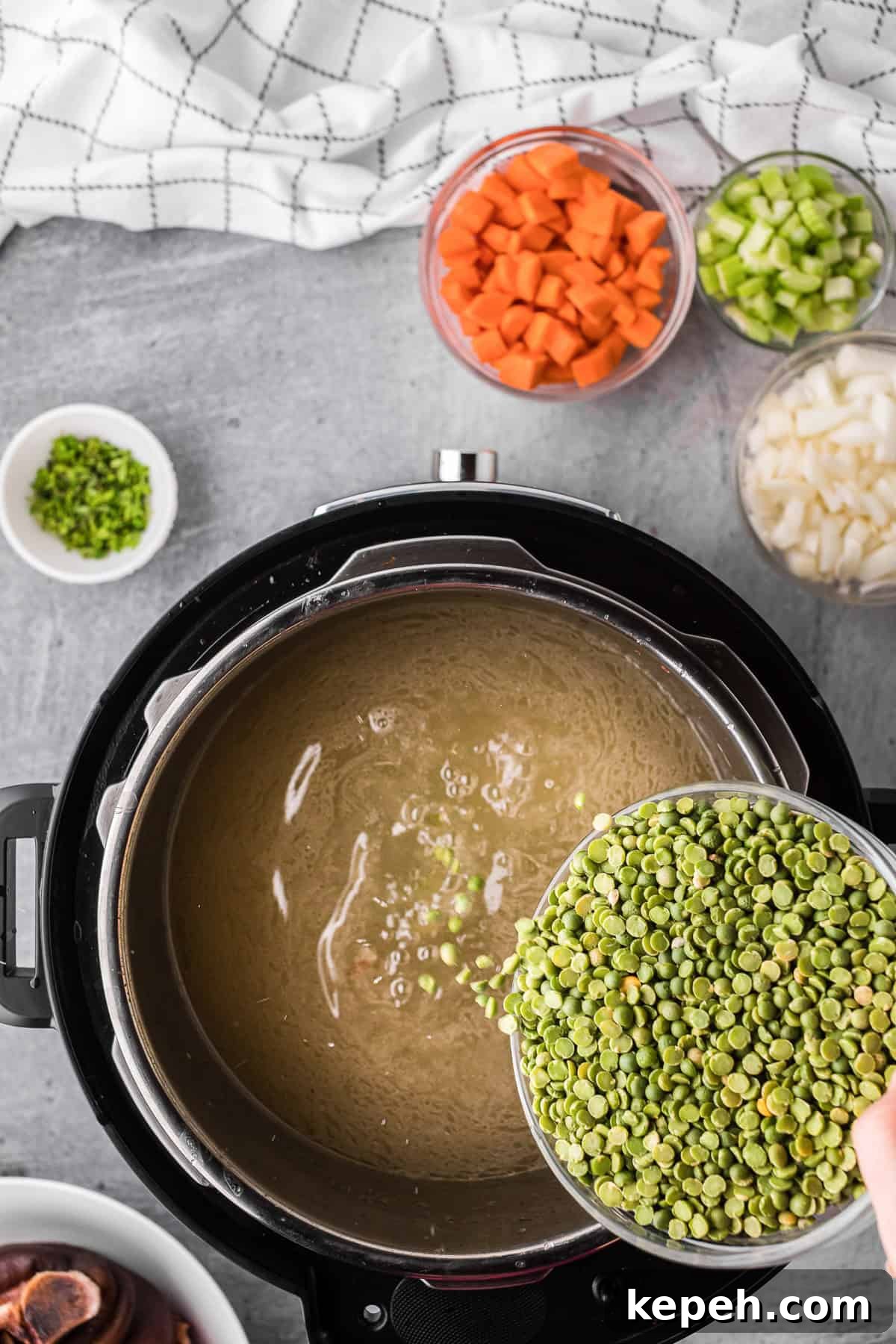 Adding dried split peas to liquid.