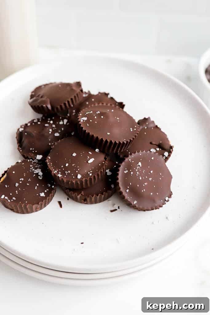 homemade protein peanut butter cups stacked on eachother on white plate