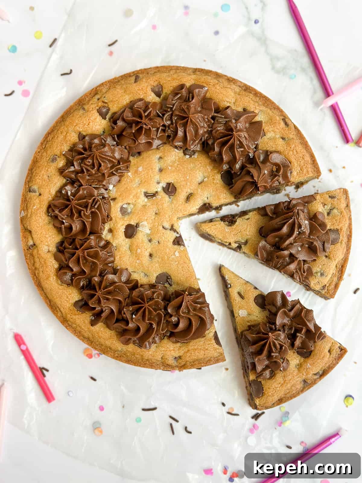 Chocolate Chip Cookie Cake Recipe: Soft, Gooey, Rich 2 chocolate chip cookie cake with two slices cut into it.