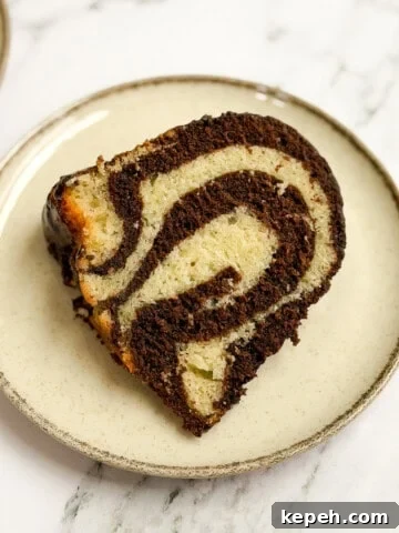 a single slice of marble bundt cake on a plate so you can see all the marbling.