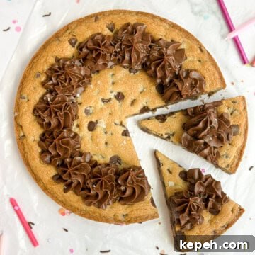 Chocolate Chip Cookie Cake Recipe: Soft, Gooey, Rich 17 chocolate chip cookie cake with two slices cut into it.