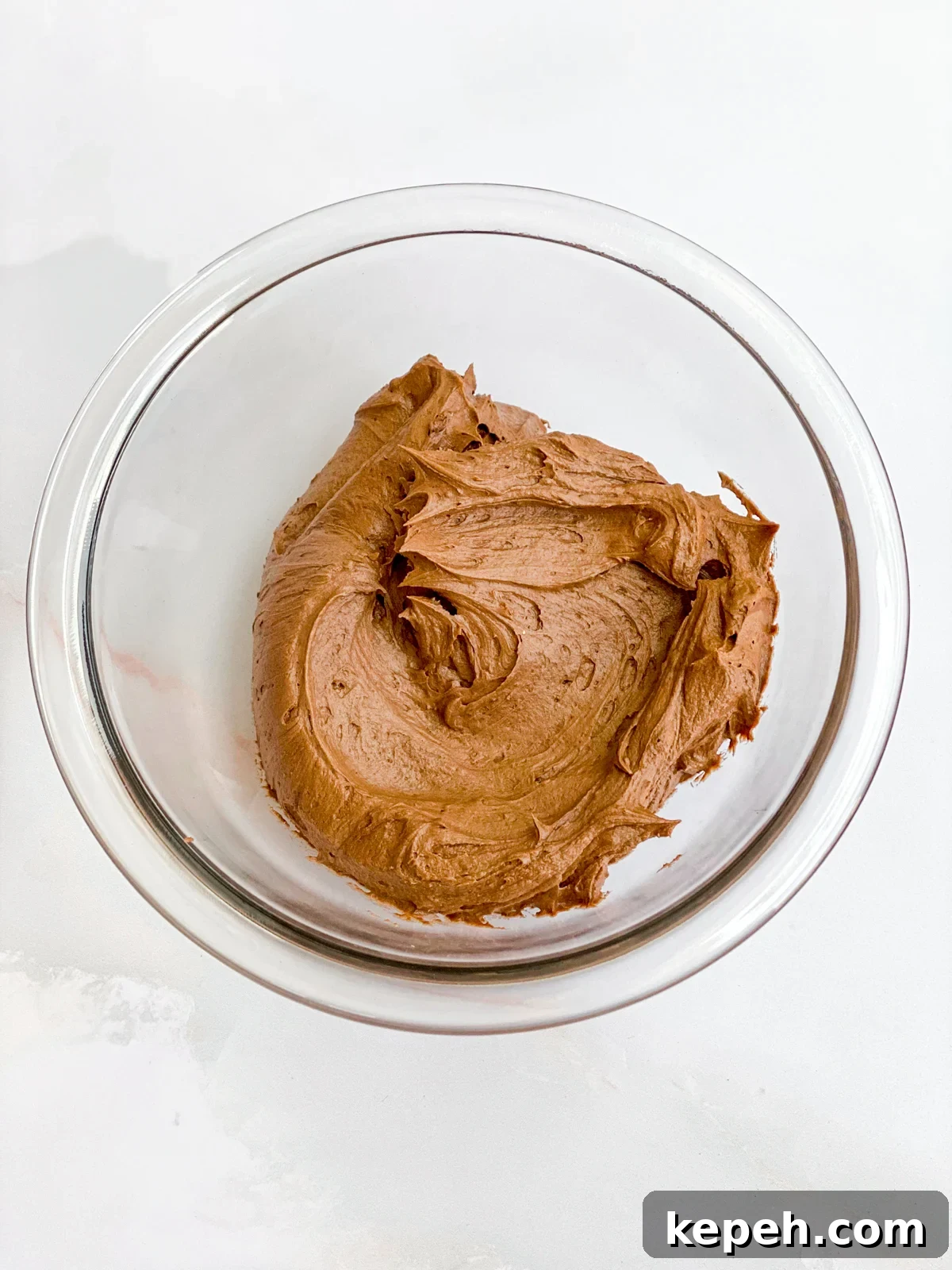 Chocolate Chip Cookie Cake Recipe: Soft, Gooey, Rich 9 frosting mixed in a bowl.