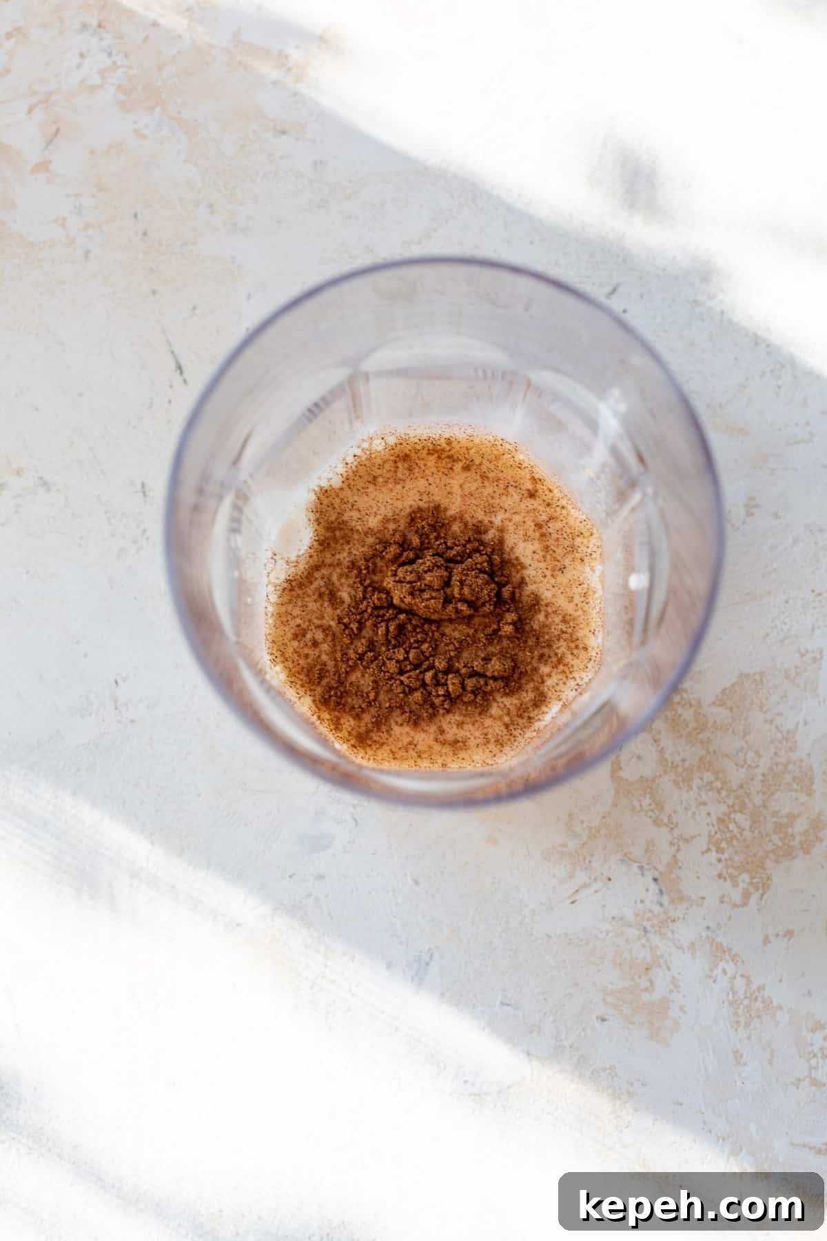 How to Make Pumpkin Cream Cold Brew 5 overhead view of ingredients for pumpkin creamer in a glass.