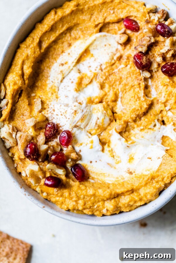 a bowl of hummus topped with nuts