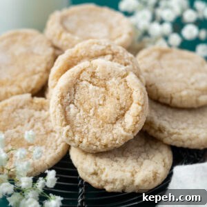 Classic Vanilla Bean Cookies with Old Fashioned Flavor 11 vanilla bean sugar cookies on a cooling rack with fresh flowers in the background