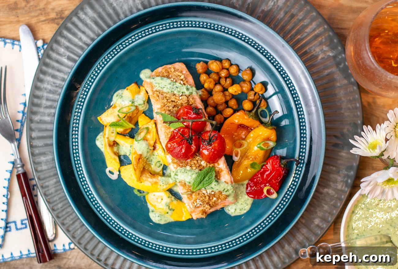 Egyptian Dukkah Sheet-Pan Salmon with Veggies and Chickpeas 4 Plating the dish with Minted Herb-Yogurt Sauce and Mint Leaves