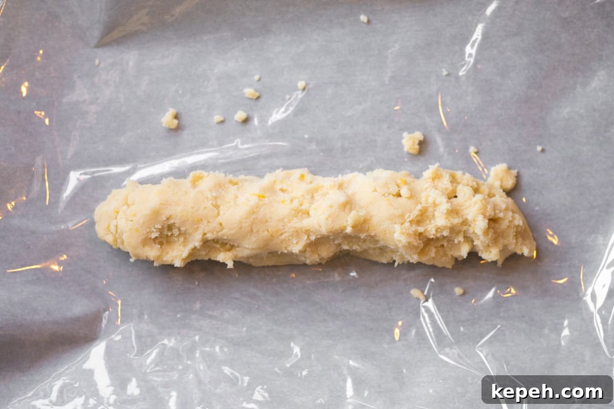 Buttery Lemon Shortbread Cookie Recipe 5 log of dough laying on cling wrap