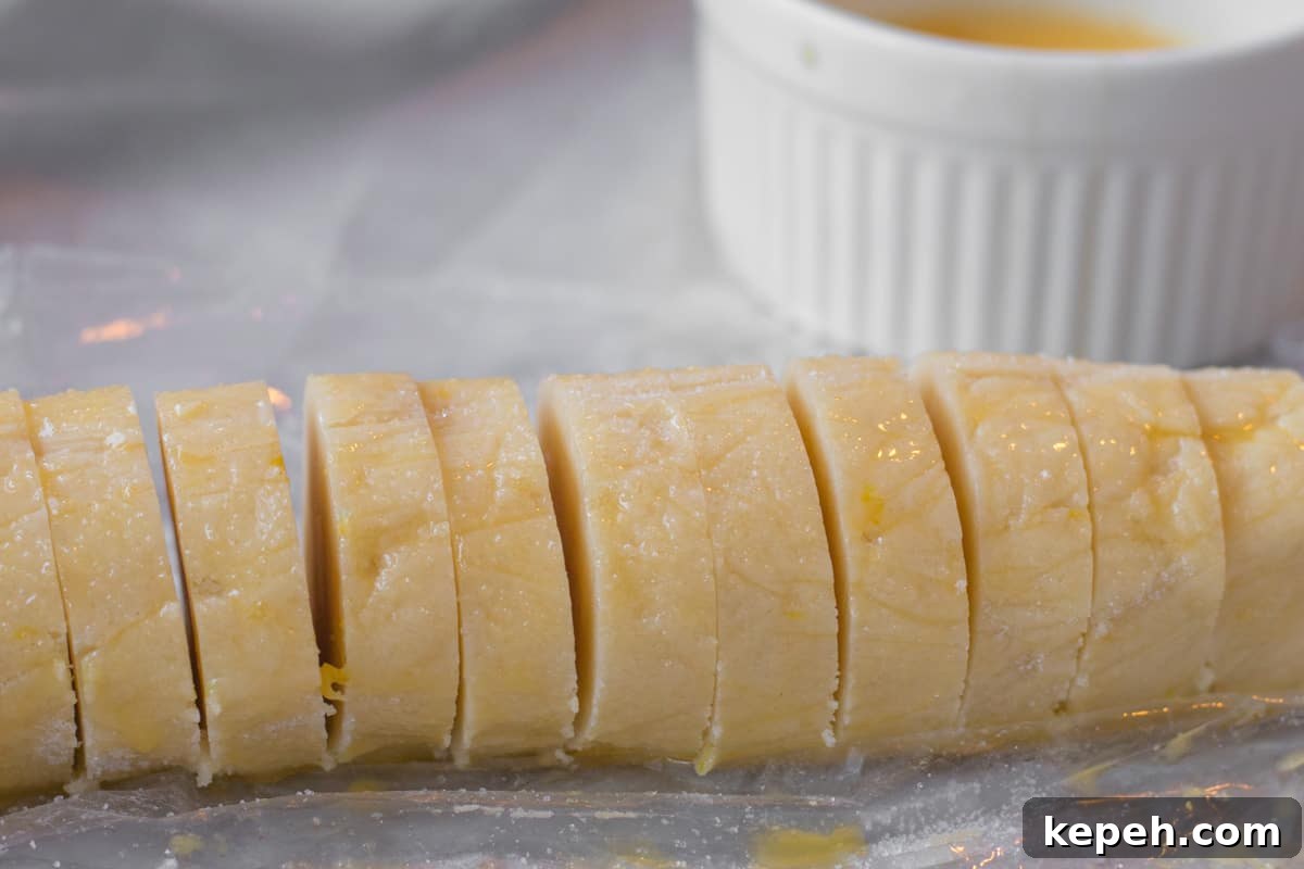 Buttery Lemon Shortbread Cookie Recipe 6 sliced cookie dough with egg wash in the background